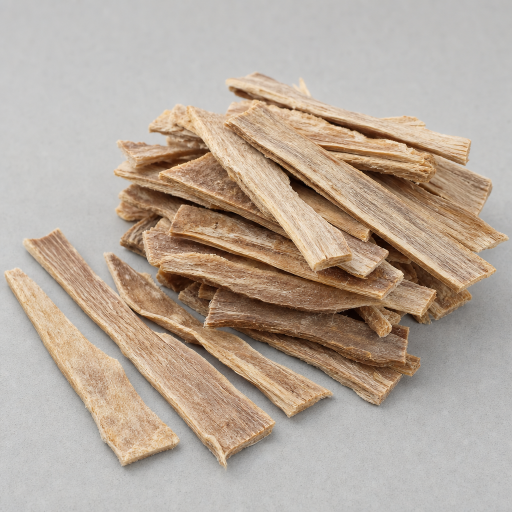 Dried pale tan collagen-rich tissue slabs cut into thin flat strips with a matte dry fibrous surface, beside a small heap of fine tan to light-brown peptide powder