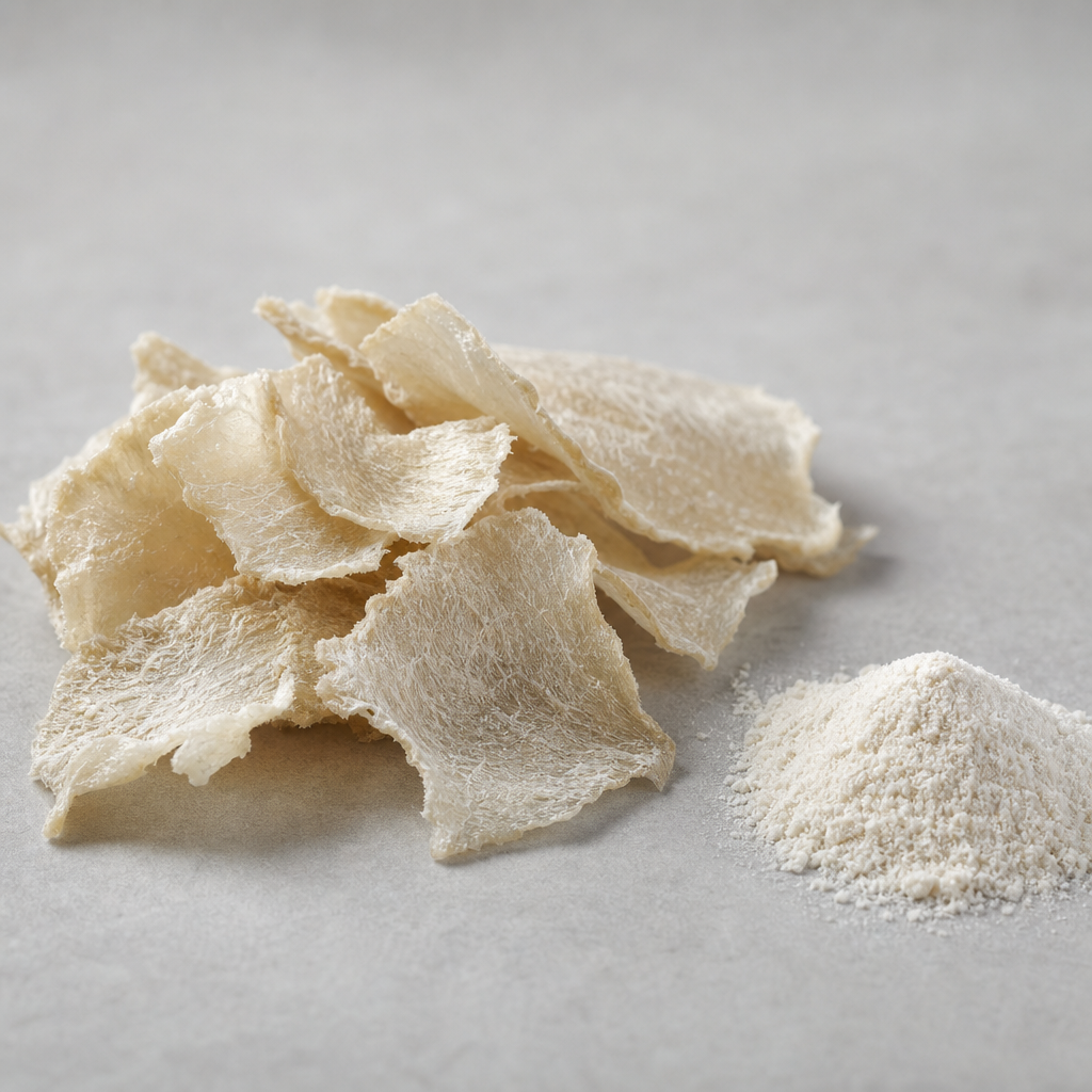 Dried off-white tuna skin collagen pieces with a rough fibrous surface beside a heap of fine collagen peptide powder