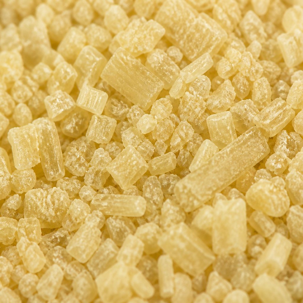 Pale yellow caffeic acid crystalline powder texture close-up
