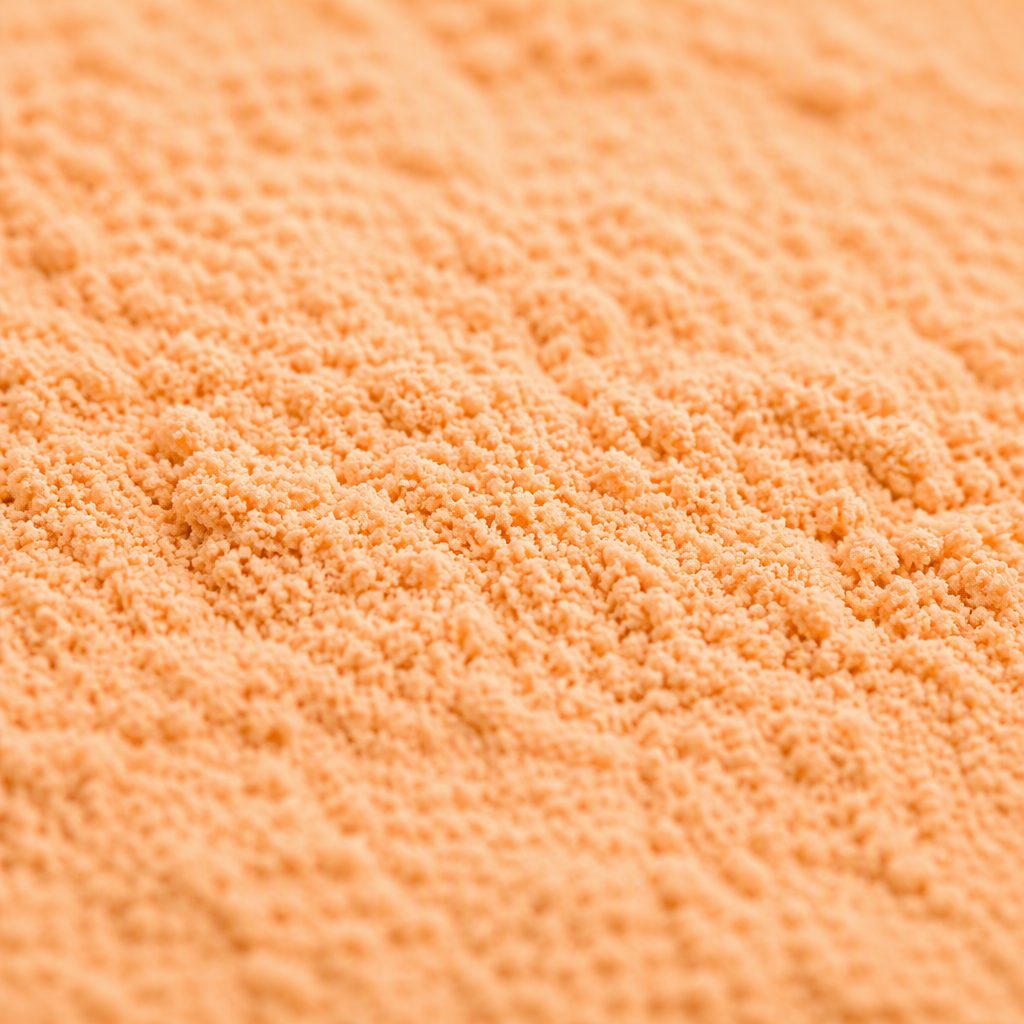 Pale orange cantaloupe powder texture close-up