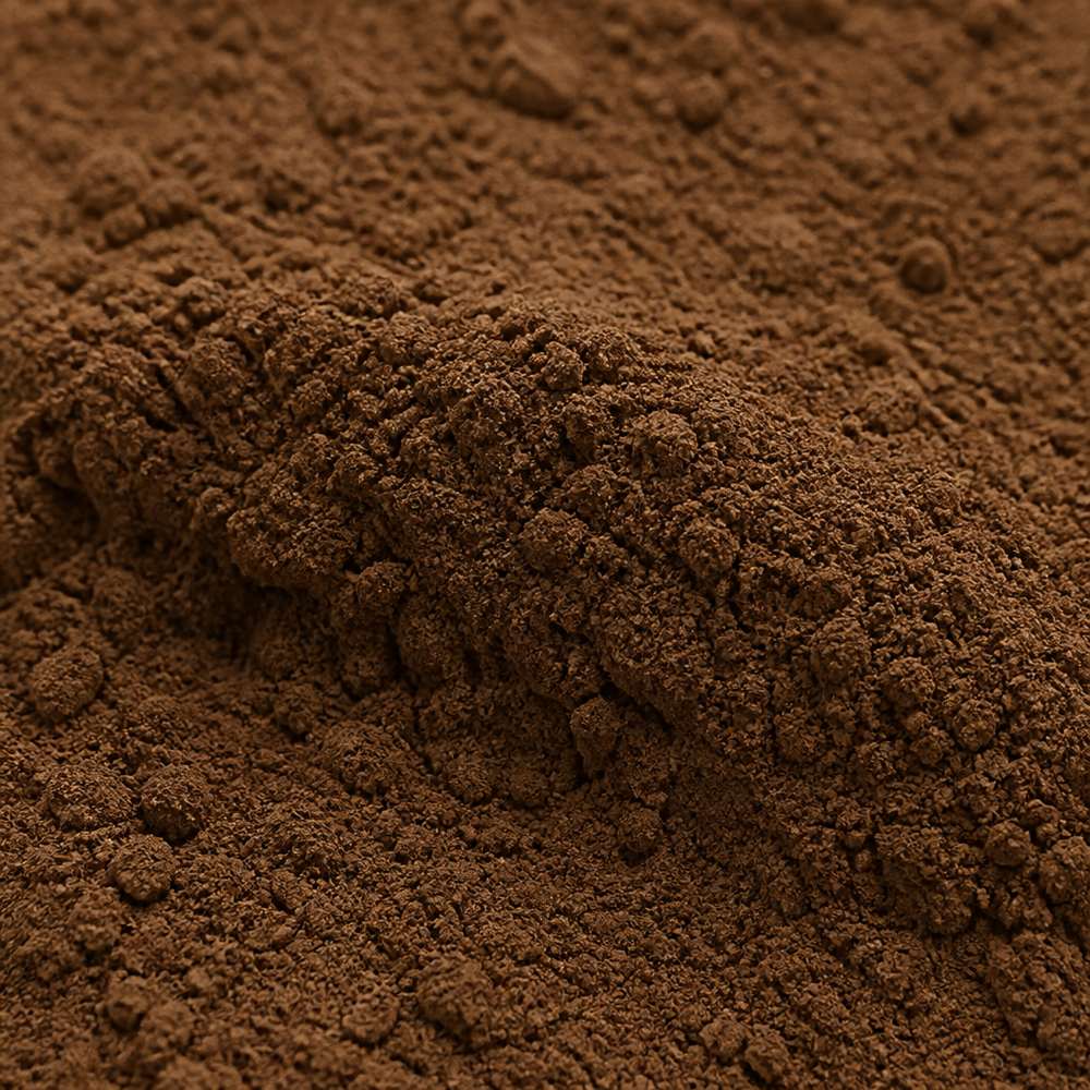 Fine medium-brown dark tea extract powder, macro texture