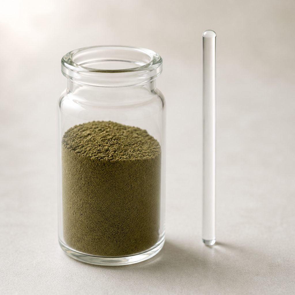Purslane extract powder in a glass jar beside an upright glass rod