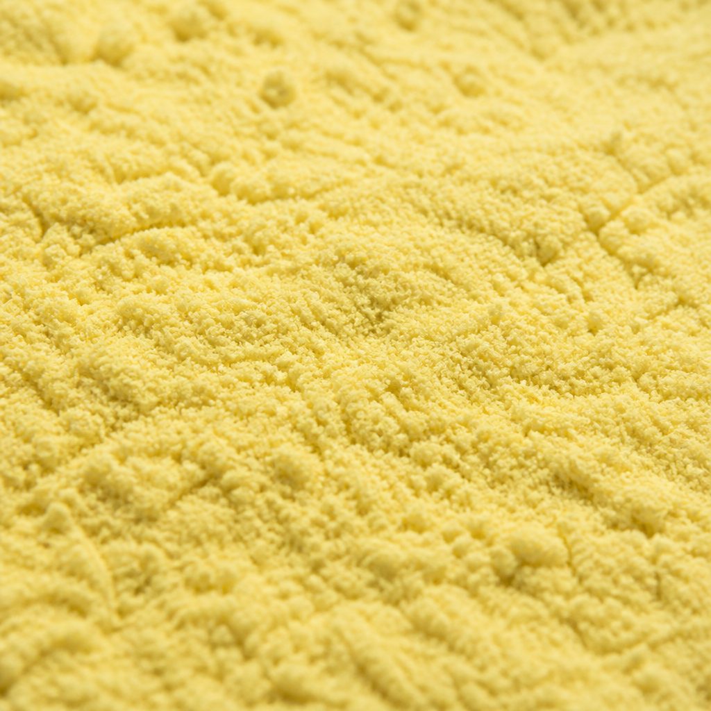 Pale yellow sulforaphane powder texture close-up